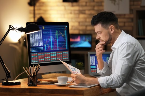 Guy sitting and looking at stock trades